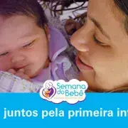 Uma mãe, sorrindo, olha para sua filha bebê. Na imagem está escrito Todos Juntos Pela Primeira Infância.